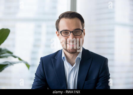 Businessman in suit looking at camera making conference video call Stock Photo