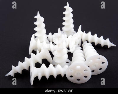 Special dowels for fixing light objects in styrofoam insulation, on black background Stock Photo