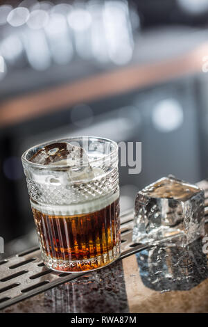 White russian cocktail drink at barcounter in night club or restaurant. Stock Photo