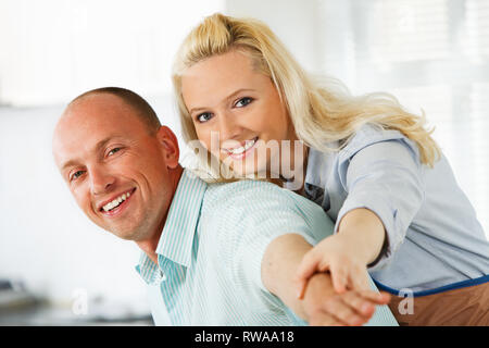 Embraced cheerful couple  having fun in their kitchen Stock Photo