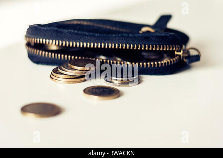 Black suede leather wallet isolated on white background with coins Stock Photo