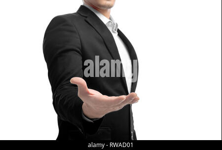 Businessman in suit standing with open palm for offer shake hands and holding or showing something isolated over white background Stock Photo