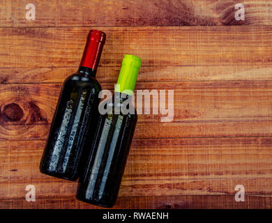 Two Bottles of Wine: Flat lay overhead shot of a bottle of blush wine on a wood table Stock Photo