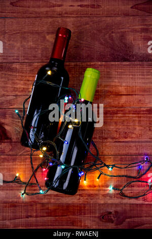 Two Bottles of Wine: Flat lay overhead shot of a bottle of blush wine on a wood table Stock Photo