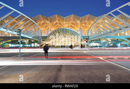 People crossing street at main entrance of Gare do Oriente station by night Stock Photo