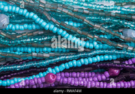 Abstract bead background - Top view photo of purple and turquoise glass beads close up Stock Photo
