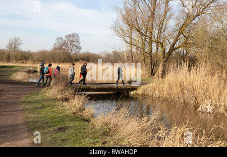 People walking beside the fens in February ,  Cambridgeshire East Anglia UK Stock Photo