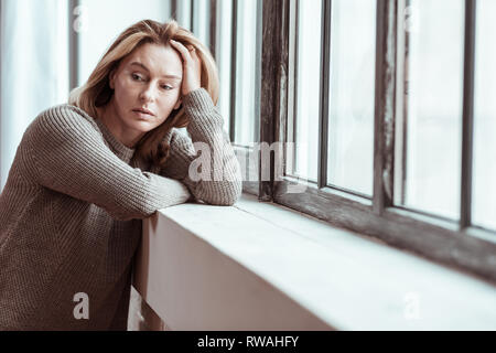 Pleasant woman feeling thoughtful having personal problems