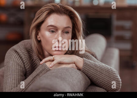 Appealing businesswoman feeling thoughtful and very concerned