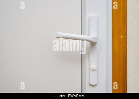 Close-up imgae white plastic doorhandle in house Stock Photo