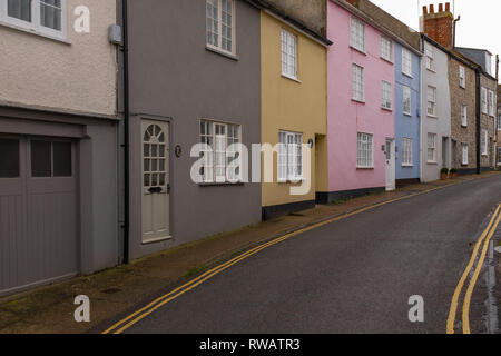 A row of colourful houses in a quiet narrow street in Lyme Regis, Dorset, England, no cars or people Stock Photo