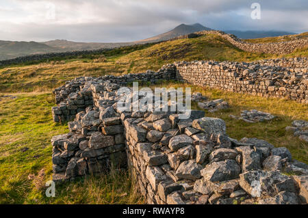Sunset view of the Hardknott Roman Fort in the English Lake District and the Scafell Mountain Range in the background. Stock Photo