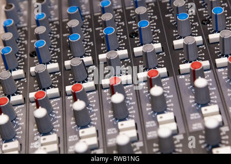 Abstract view of Professional audio mixing console with faders and adjusting knobs -Music / radio / TV broadcasting Stock Photo