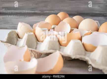 Closeup view of raw chicken eggs in an egg box on white background Stock Photo