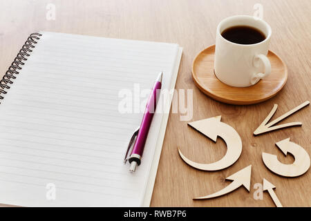 top view image of open notebook with blank pages next to cup of coffee on wooden table. ready for adding text or mockup Stock Photo
