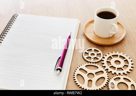 top view image of open notebook with blank pages next to cup of coffee on wooden table. ready for adding text or mockup Stock Photo