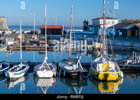 France, 2018, France, 2018, Reflection of moored fishing boats on the harbour’s water. Stock Photo