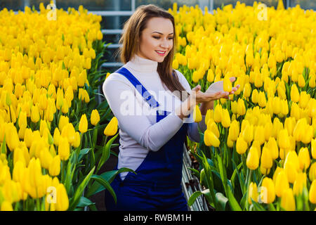 beautiful woman and a lot of yellow tulips Stock Photo