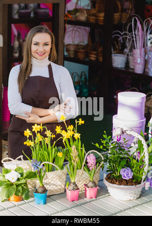 Portrait owner of a flower shop standing with flowers Stock Photo