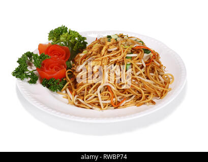 Fried noodles - a typical Asian/Chinese dish. Served on a white plate, garnished with tomatoes and salad. Stock Photo