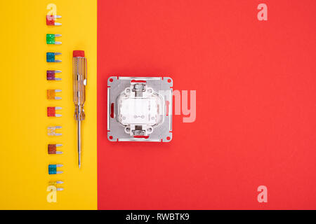 Set of electrical tool and white socket on colorful background Stock Photo