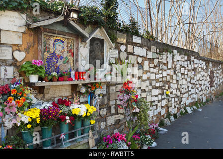 Shrine of popular faith. Numerous small plaques of gratitude placed in response to answered prayers - Via di Portonaccio (near Largo Preneste) - Rome Stock Photo