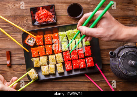 Sushi Set rolls with soy sauce served on black plate Stock Photo