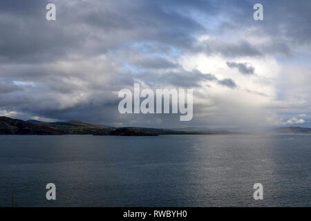 County Donegal (Fanad Peninsula), Ireland. 05 March 2019. Irish weather - a mixed day of heavy rain, showers and sunshine. Temperatures slightly up but expected to fall to around 7-8C tomorrow. Looking across Lough Swilly to the Inishowen Peninsula and a rain shower over Buncrana. Credit: David Hunter/Alamy Live News. Stock Photo