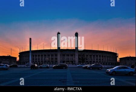 Berlin, Deutschland. 18th Feb, 2015. The Olympiastadion Berlin in the Berlin district of Westend in the dusk with a beautiful evening sky from the Olympic Square. The striking east gate with the two 35 meter high towers, the bavarian tower on the left (south) and the Prussian tower on the right (north), the five Olympic rings and the new Podbielskieiche. The stadium was designed by the architect Albert Speer and today is the home ground of the football Bundesliga team Hertha BSC. | usage worldwide Credit: dpa/Alamy Live News Stock Photo