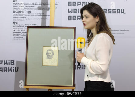 March 6, 2019 - Kiev, Ukraine - An Ukrainian journalist stands next to the painting of self-portrait by Russian artist Kazimir Malevich, at the opening of the exhibition ''Avant-garde. In search of the fourth dimension'' in the center of modern art ''M17'' in Kiev, Ukraine, on 06 March 2019. According to representatives the M17, for the first time in Ukraine presented a previously unseen self-portrait by Russian artist Kazimir Malevich, which he painted 11 months before his death. ''Now i look like Marx in a grave. When I go out, the children shout Karl Marx,'' signed the author on a self-port Stock Photo