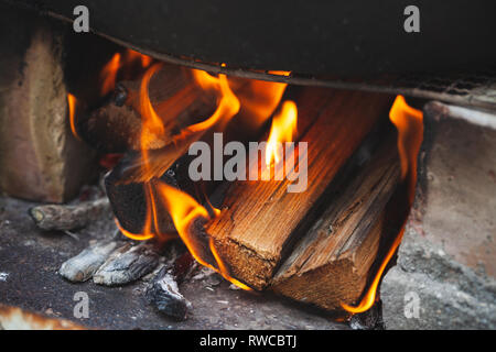 Close up photo of outdoor bonfire, flame over firewood Stock Photo