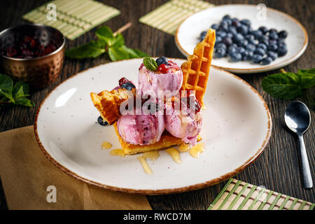 Fresh waffles with ice cream and maple syrup Stock Photo