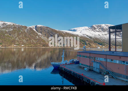 Looking across the Fjord from the Batbygg Shipyard in Maloy on one early Winters morning with snow topped mountains as a backdrop. Norway. Stock Photo