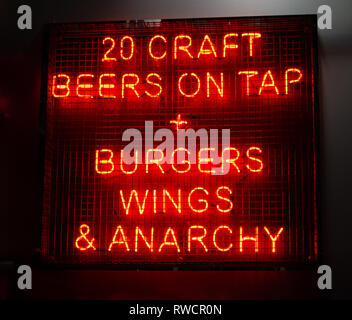 Neon sign, 20 Craft Beers on Tap + Burgers Wings & Anarchy, London, UK Stock Photo