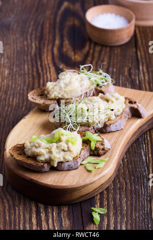 Fish pate, minced herring fillet with apple and egg on toasted rye bread, homemade traditional Jewish cuisine dish forshmak, snack or appetizer on rus Stock Photo