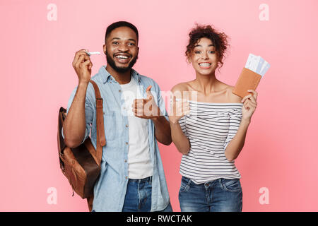 African-american couple ready for travel, showing thumbs up Stock Photo