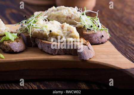 Fish pate, minced herring fillet with apple and egg on toasted rye bread, homemade traditional Jewish cuisine dish forshmak, snack or appetizer on rus Stock Photo