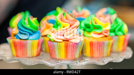 Colorful cupcakes with rainbow cream for Carnival Stock Photo