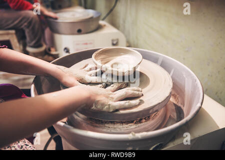 Artisan potter prepares material clay for pottery. Man knead clay before  molding. Male sculptor is pugging and kneading clay for creating ceramics  in Stock Photo - Alamy
