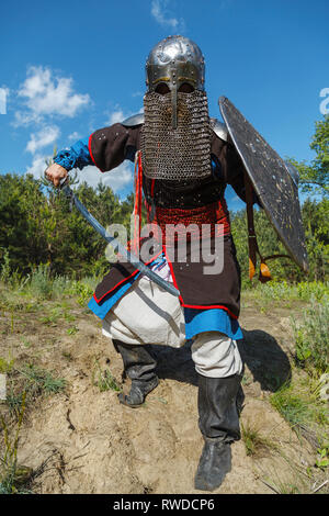 Mongol horde warrior in armour, holding traditional saber. Stock Photo