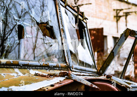 Vehicles left to decompose out the back of the police station inside the  Chernobyl exclusion zone Stock Photo