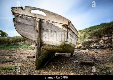 An old boat discarded on a beach Stock Photo