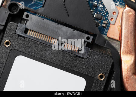installing new solid-state drive to laptop pc. sata and power connection close up.upgrade laptop hardware. Stock Photo