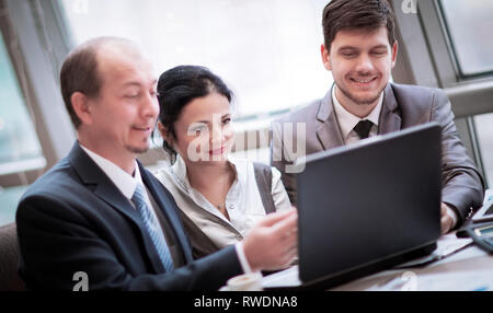 adult businessman discussing financial documents with a young colleague. Stock Photo