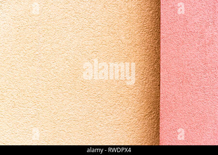 The new house facade in pink on the right and beige on the left in daylight Stock Photo