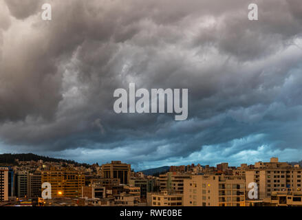 Storm weather above the modern city part of Quito located in the Andes mountain range of Ecuador, South America. Stock Photo