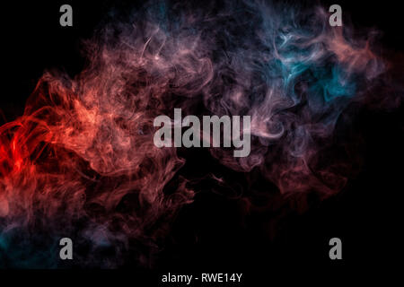Abstract art  red and blue colored smoke on black isolated background. Stop the movement of multicolored smoke on dark background Stock Photo
