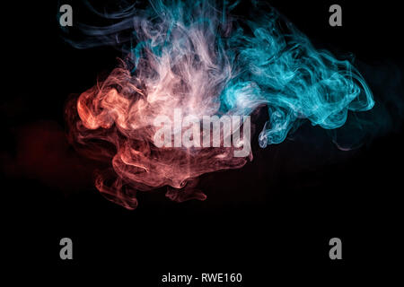 Thick colorful smoke of red, blue on a black isolated background. Background from the smoke of vape Stock Photo