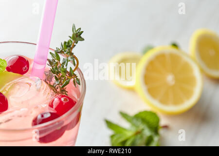 Lemonade with ice and fresh lemon with mint on wooden background. horizontal view. copy space. refreshing summer drink. Stock Photo