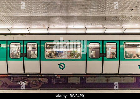People on a Paris Metro train at St Georges Metro station in the 9th arrondissement of Paris, France Stock Photo